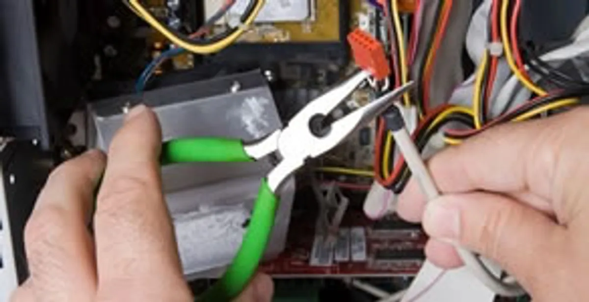 Licensed electrical contractor performing electrical repair with tools in Kaysville, UT