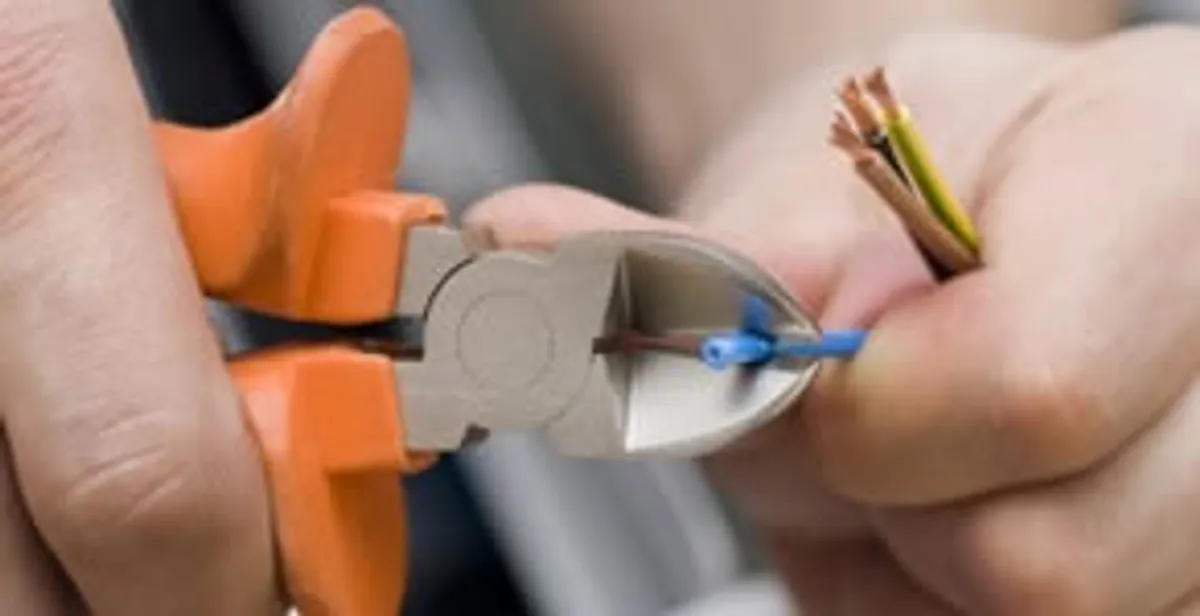 professional electrical services showing precise wire cutting by licensed electricians in Ogden, UT